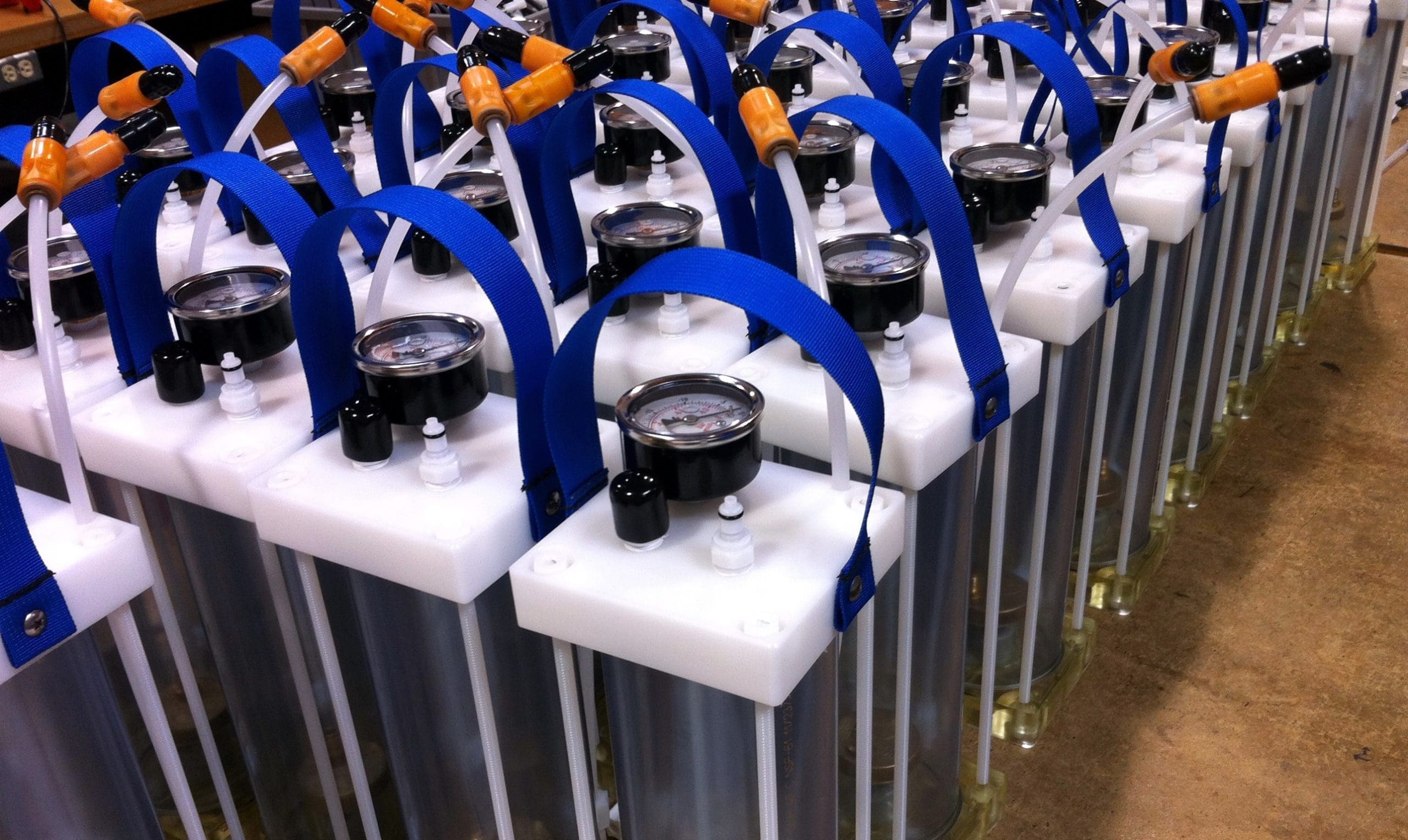 Tank Assemblies for Dispensing Tank dispensing assemblies with blue pneumatic tubing